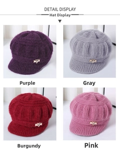 Detailed close-up of knit winter hats in four colors with crystal butterfly decoration