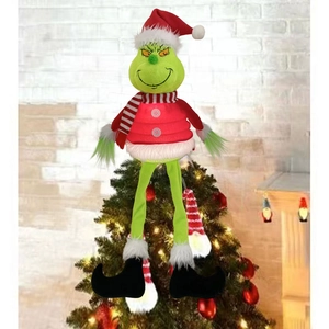 Grinch Christmas tree topper plush ornament with red hat and scarf on a festive tree
