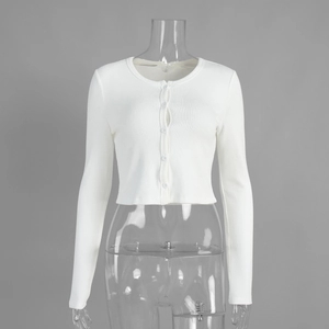 Detail of white ribbed knit cropped cardigan with button-up front and crew neck finish