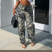 Detail of gray camouflage cargo pants featuring large side pockets and a street style design