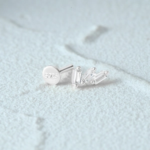 Macro view of S925 sterling silver moon cartilage stud with three rectangular gemstones