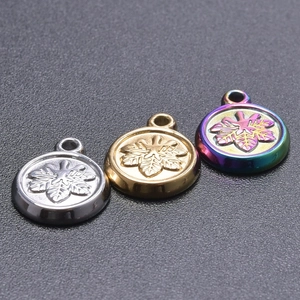 Detailed close-up of three circular snowflake pendants in silver, gold, and rainbow finish