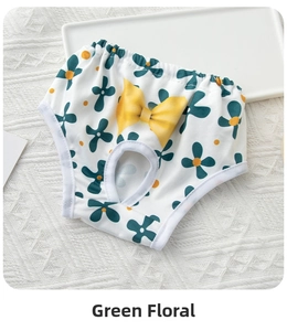 Detail view of cotton dog physiological pants featuring green floral print and a yellow bow