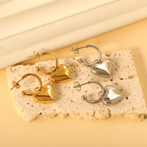 Minimalist stainless steel heart dangle earrings in gold and silver on stone