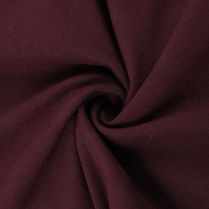Macro view of burgundy fabric texture showing fine weave and soft drape of the backless top