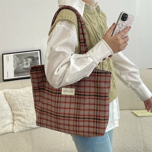 Detailed close-up of a plaid woolen tote bag with colorful vintage check pattern
