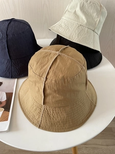 Close-up of quick-dry nylon sun hats in navy, beige, black, and khaki with reinforced stitching