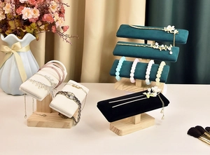 Detail view of multi-level solid wood jewelry stand with velvet T-bar for watches