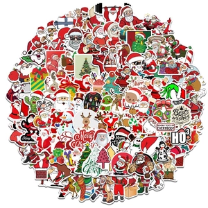 Pile of colorful Christmas stickers featuring Santa Claus and reindeer on white background