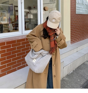 Chic beige faux lamb wool tote bag styled with a trendy winter outfit for daily shopping