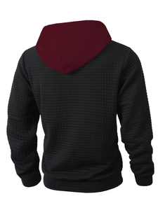 Detail of men's black quilted hoodie with burgundy hood and 3D grid texture