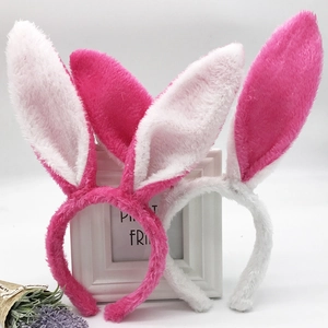 White and pink plush sequin rabbit ear headbands for Easter with a minimalist floral background