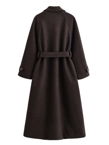 Detail view of the back of a dark brown wool coat with matching waist belt and sharp tailoring
