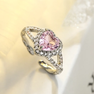 Macro shot of an adjustable silver ring featuring a large pink heart zircon center stone