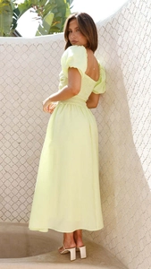 Close-up of smocked back detailing on a light yellow puff sleeve vacation dress