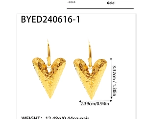 Detail of golden heart earrings featuring hammered metal texture and hook closure