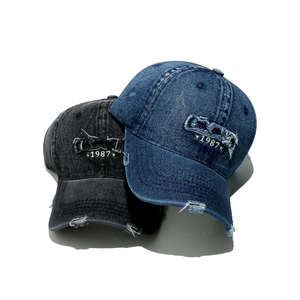Vintage distressed denim baseball cap with 1987 embroidery and ripped brim detail
