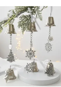 Detail of silver vintage metal bells with snowflake and reindeer pendants for Christmas trees
