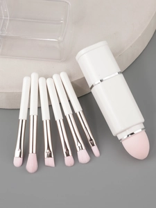 Detail view of 8-in-1 portable makeup brush set with pink sponge head and travel case