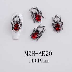 Gothic black spider nail charm with a large red teardrop gem and detailed metal legs