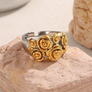 Macro detail of vintage 18K gold floral ring with mixed silver band on natural stone