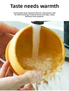 Water rinsing a yellow food-grade silicone baby bowl with non-slip suction base