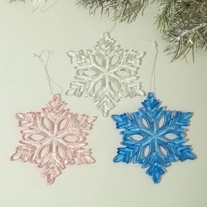 Detailed view of acrylic snowflake pendants in transparent pink and blue colors