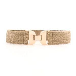 Detail of khaki elastic woven belt featuring a polished golden geometric metal buckle