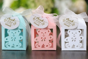 Detailed view of hollow bear paper candy boxes with ribbons and thank you tags in three colors