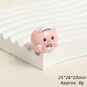 Detail of pink resin pig figurine with size 25x26x20mm on white wave display