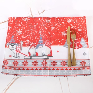 Christmas place mat with Santa gnome and reindeer pattern on red linen background