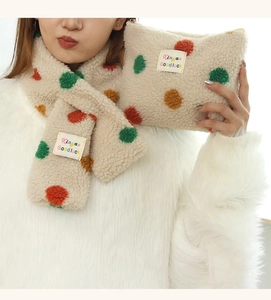 Detailed texture of plush polka dot fabric and brand label on a soft lamb fleece vanity bag