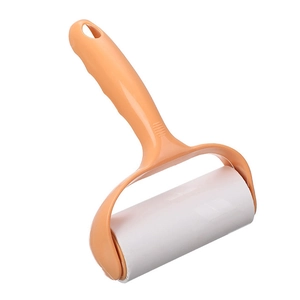 Portable light orange lint roller with ergonomic handle and white sticky paper roll