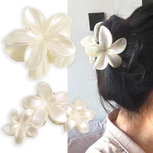 Elegant pearlescent lily flower hair claw clip and styling on a woman's hair