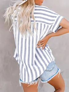Back view of a grey and white striped short sleeve shirt paired with denim shorts