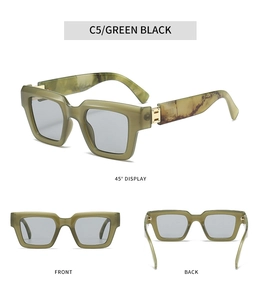 Detail view of square green marble sunglasses with gold hinge and grey lenses