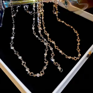 Metallic heart tassel necklace with pavé zircon stones in gold and silver finishes