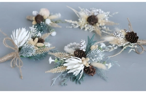 Detail of forest style wedding boutonnieres and wrist corsages with pine cones