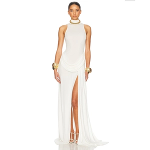 Detail of white sleeveless halter maxi dress with waist draping and high side slit