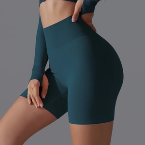 Detail view of seamless high waist shorts and thumb hole sleeves in dark green knit fabric