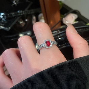 Detailed macro shot of a French vintage ring with a red oval gem and pavé zircon stones