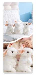 Close-up of soft white plush bunny toy showing fluffy texture and cute sitting pose