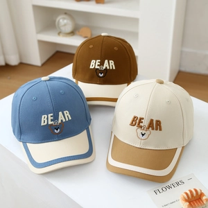 Detailed embroidery of bear motif and BEAR text on colorful cotton canvas baseball caps