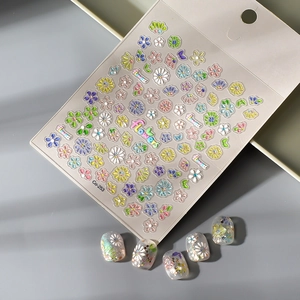 3D floral nail art stickers with colorful daisies and rainbow lettering on model nails