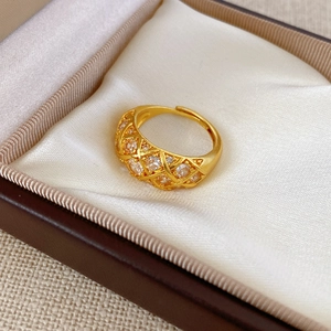 Macro shot of gold-plated lattice ring with sparkling zircon in luxury jewelry box