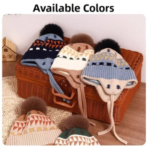 Close-up of winter knit hats with pom-poms and jacquard tree patterns in a basket