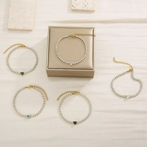 Detailed view of heart-shaped tennis bracelets with colorful crystals and gold plating