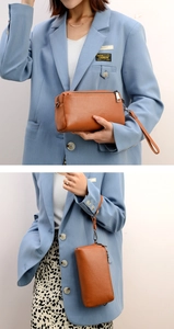 Detailed view of brown lychee texture leather handbag with strap and metal zipper