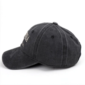 Detail view of washed cotton fabric with vintage gray finish and embroidery on baseball cap