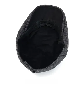 Detailed interior of dark grey plaid flat cap showing black lining and reinforced stitching